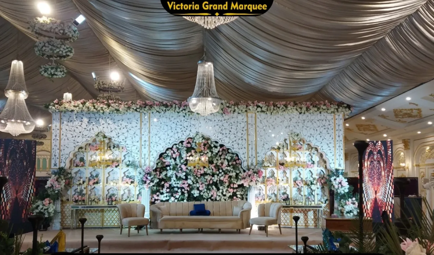 Walima stage with ivory drapery and candlelit florals