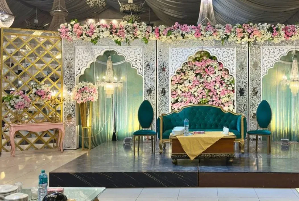 Floral arches framing the couple's stage in the main hall